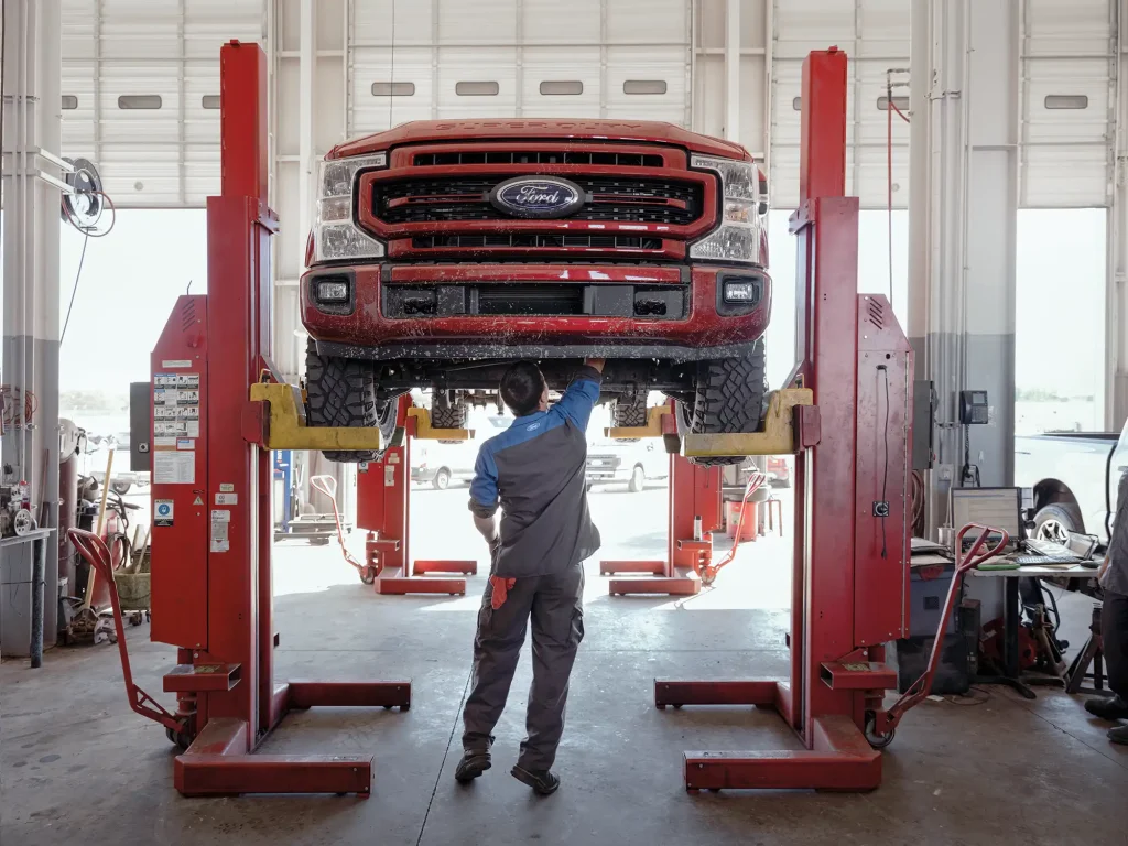 Technician performing vehicle maintenance